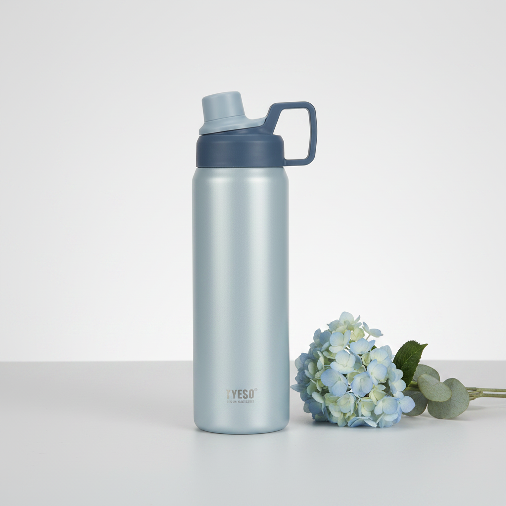 YESO Insulated Sports Water Bottle Silver Grey with hydrangea flowers lifestyle